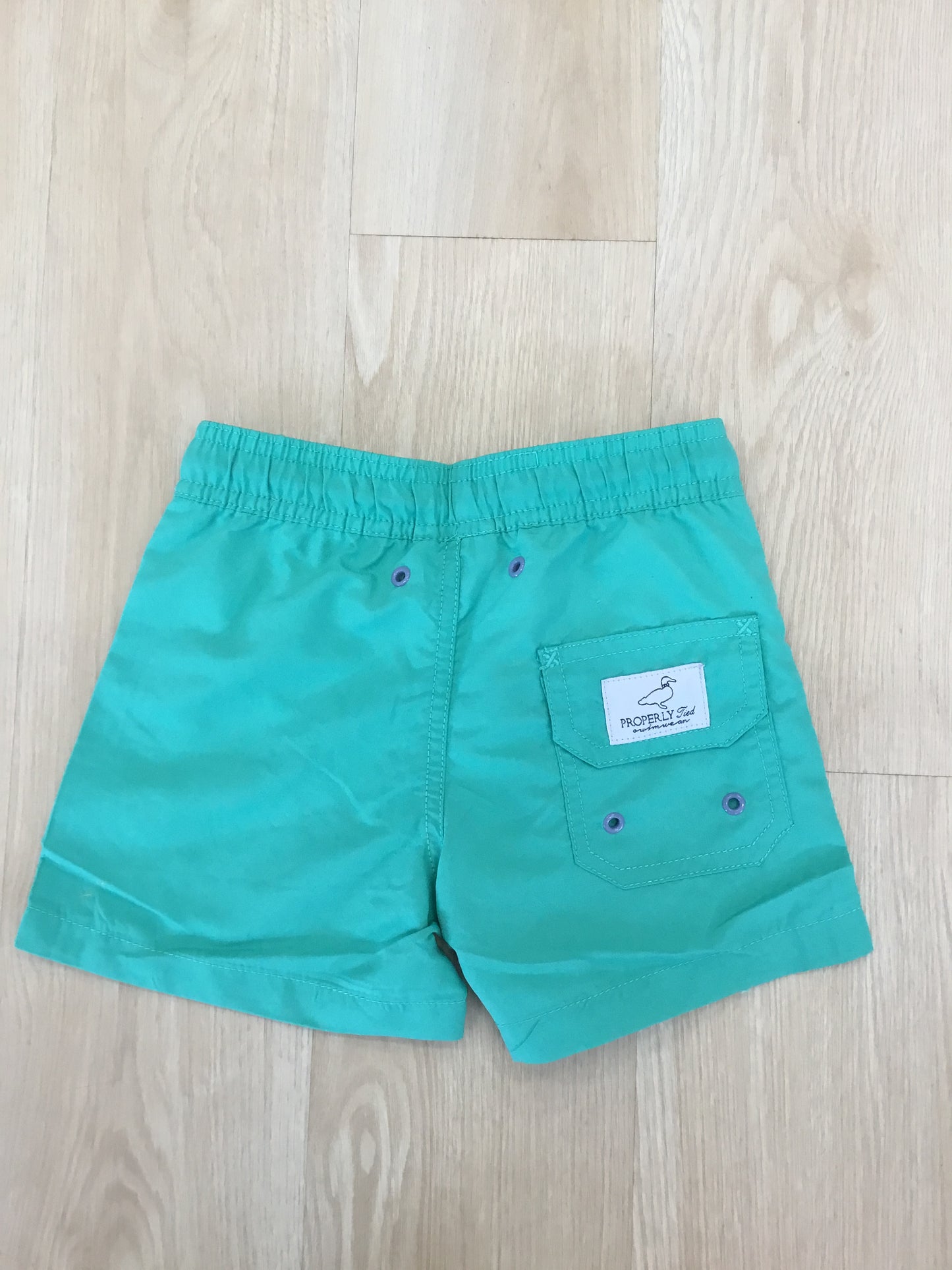 SOFT GREEN SWIM TRUNKS